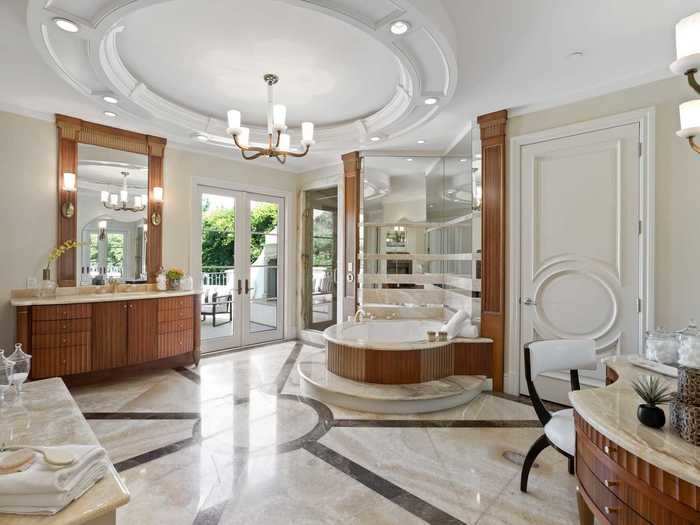 The bathrooms have marble countertops and a vanity mirror.