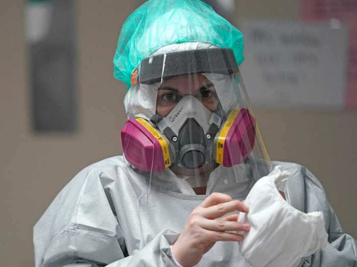 Healthcare workers treating coronavirus patients are required to wear two sets of protective equipment (PPE). The AP