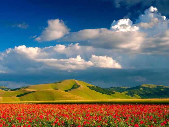 The village overlooks the Piano Grande, a basin in the Sibillini Mountains.