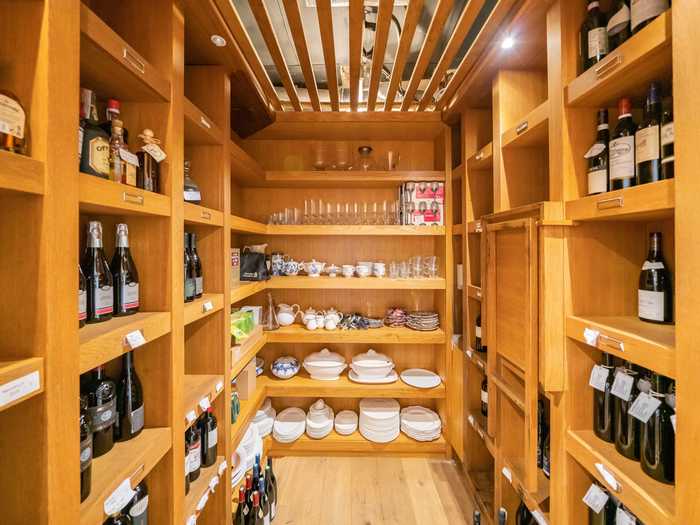 Next to the kitchen, a walk-in pantry also serves as a wine cellar. The current owner