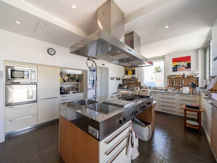 The cream and chrome-colored kitchen is fully-equipped with all modern appliances.