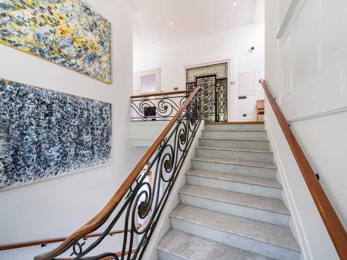 An original Art Nouveau elevator connects all six levels of the villa. The decorative detail matches the wrought iron style of the master staircase.