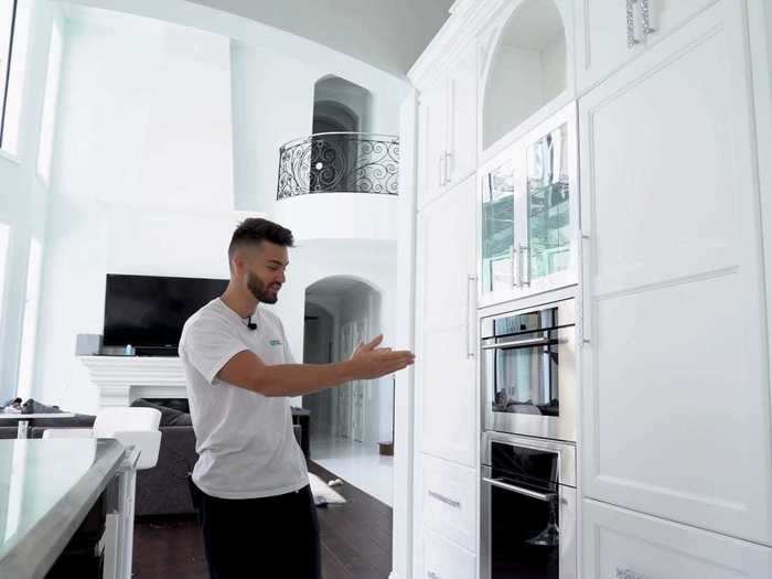 The kitchen looks newly upgraded, with two refrigerators and four freezers.