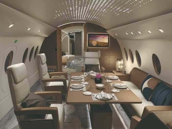 In the center of the aircraft over the wings is the conference area, a staple of any large-cabin private jet complete with seating for seven around a large table.