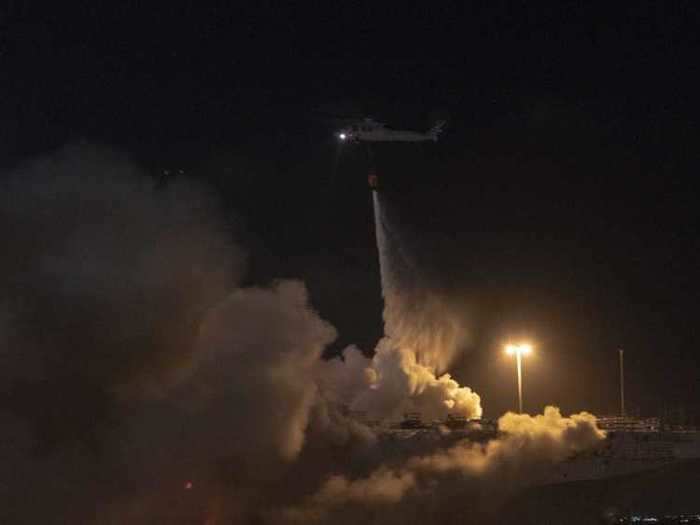 At 10:30 pm Sunday, helicopters outfitted for firefighting operations from Helicopter Sea Combat Squadron Three dumped water on the burning warship.