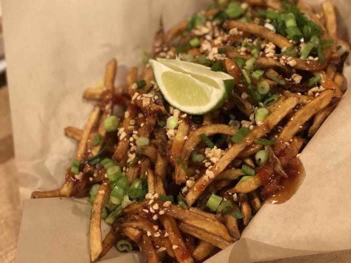 WYOMING: Crowbar & Grill in Laramie totally changed the game with its delicious loaded pad thai fries covered in sweet and spicy pad thai sauce, chopped peanuts, green onion, and lime.