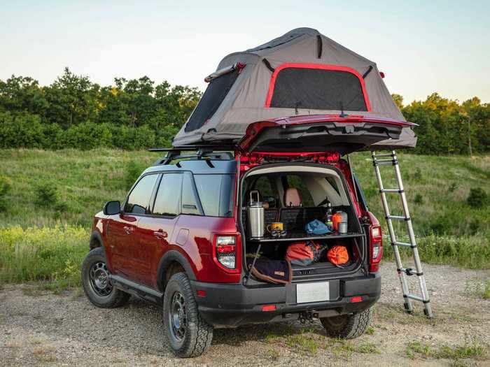The back ends of the SUVs have been configured so that they can be camping command centers.