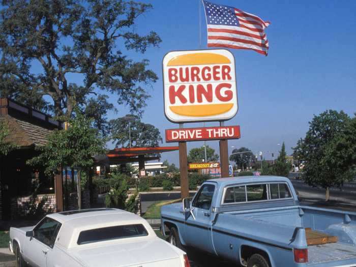 An early version of the Burger King logo featured curved letters sandwiched between two yellow burger buns.