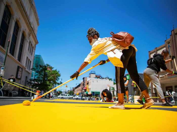 In Brooklyn, a massive street mural was painted in yellow letters along a 565 foot stretch of road.