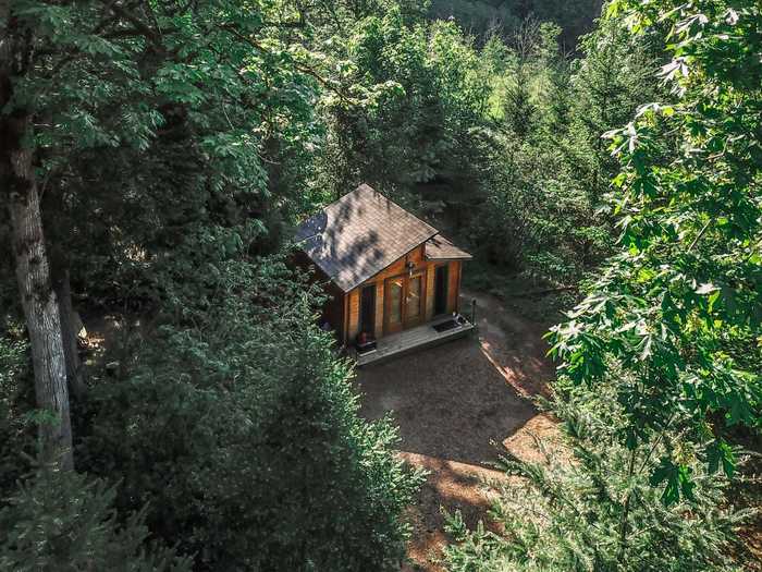 The wood-paneling and string lights inside this tiny house near Portland, Oregon, are great, but have nothing on the private open-air shower and Jacuzzi.