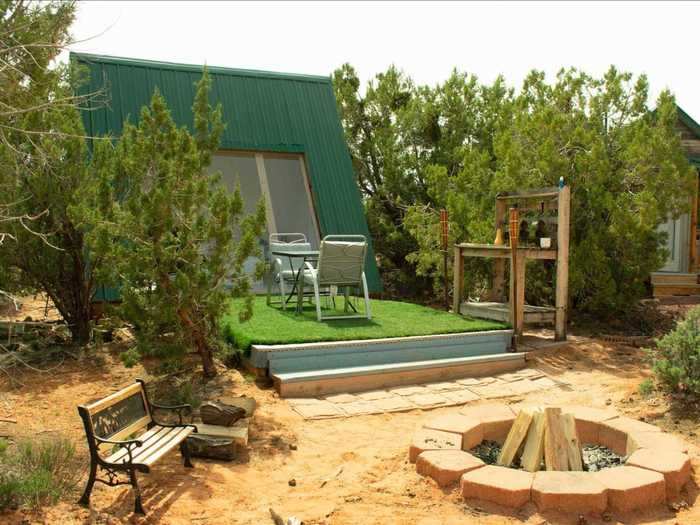 This A-Frame tiny house in the Utah desert an hour south of Zion National Park has a large skylight over the bed for stargazing plus an outdoor entertaining area with views of the surrounding red rock formations.