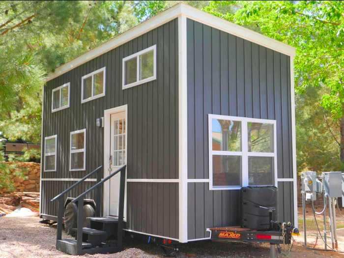 Though unassuming from the outside, this boxy tiny house in Utah has a bright, minimalistic interior and access to a private, enclosed garden with a barbecue, fire pit, and hammock.