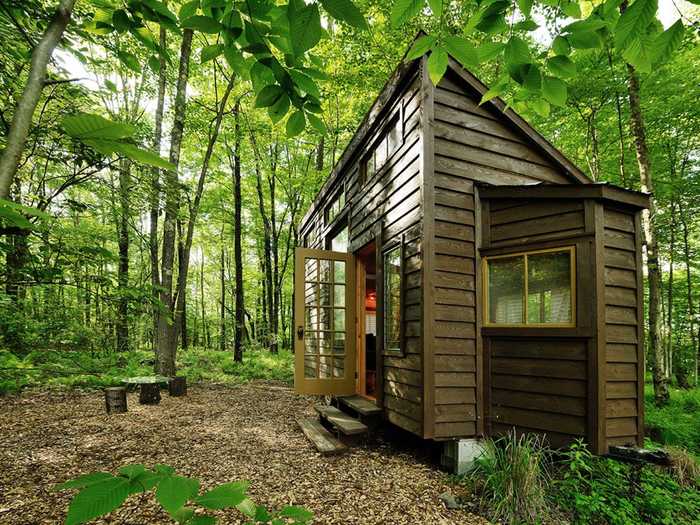 Leafy cover makes this wood-paneled tiny house on a farm in upstate New York feel worlds away from Manhattan. Guests can opt to relax in the hammock by the pond, or pay a visit to the farm