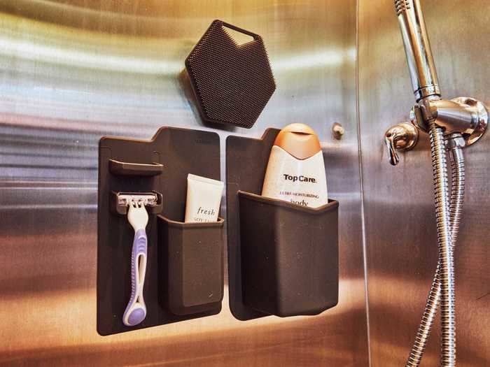 The shower also has holders for personal hygiene products, such as a razor and body wash.