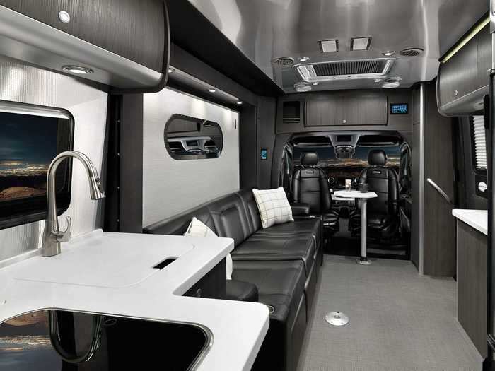 The Airstream Atlas has a kitchen, a bathroom, and a living space.