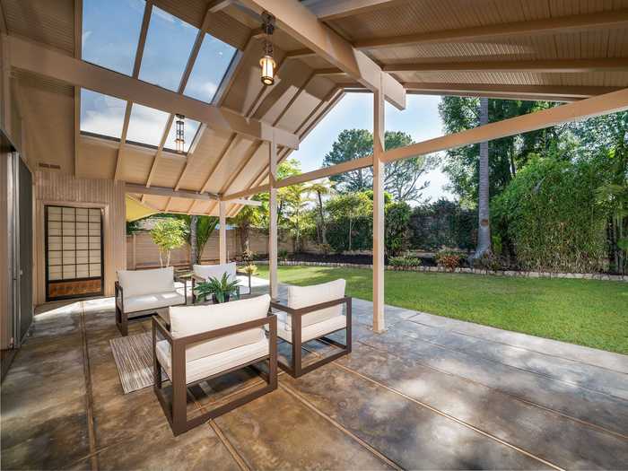 Outside, a Japanese engawa borders the house, widening into a veranda in front of the living room.