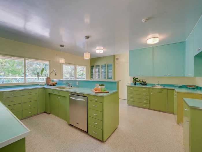 But turquoise Formica, avocado-hued cabinets, and yellow accents make the kitchen pop with color.