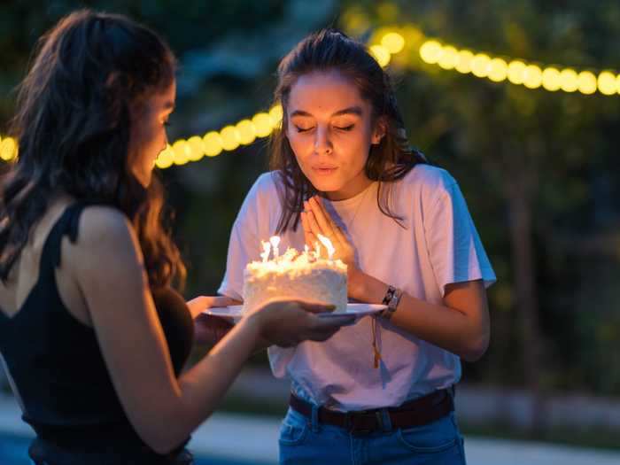 Blowing out candles on a birthday cake would