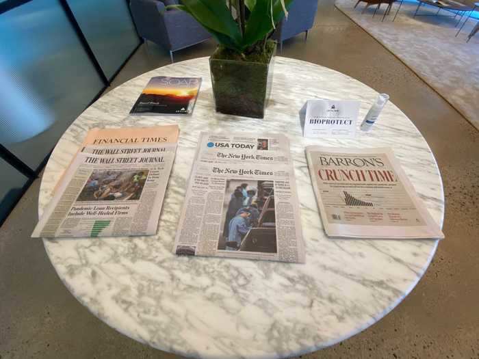 Passengers are immediately welcomed by a table full of newspapers,