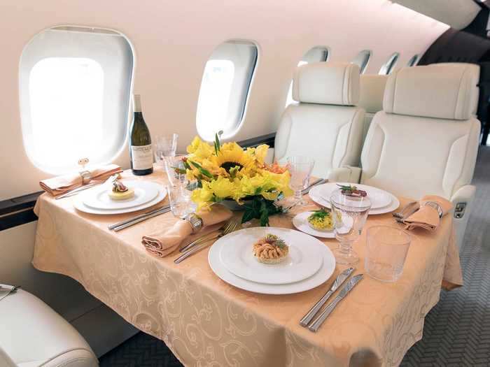 The large dining room table is ideal for use during mealtimes and is another staple of wide-cabin jet travel.