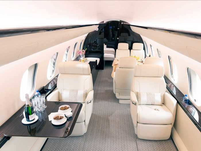 The interior cabin features three living areas with an open concept configuration in the forward sections.