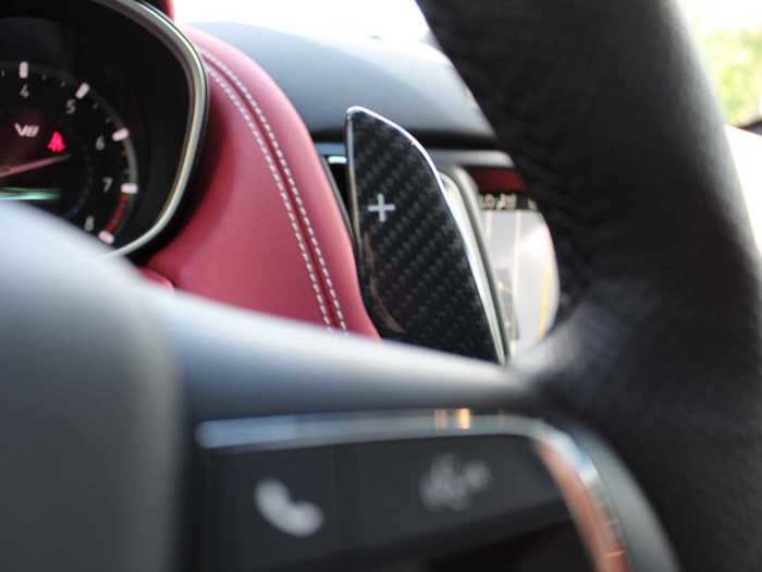 The multifunction steering wheel is leather-wrapped. Mounted on the steering column is a pair of long, carbon-fiber paddle shifters.