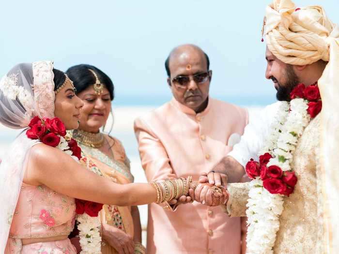 A sheet was held up to keep the couple from seeing each other as Chavda entered the mandap.