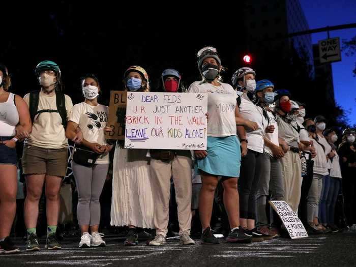 To help protect protesters from being arrested or hurt, a group of local women formed a non-threatening "wall of moms" in front of demonstrators on Saturday and Sunday.