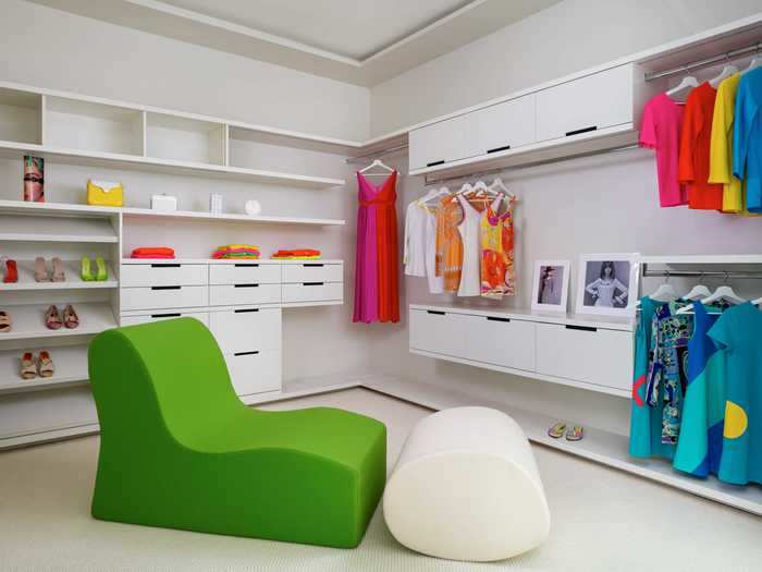 The master closet is spacious and is also outfitted with vibrant furniture.