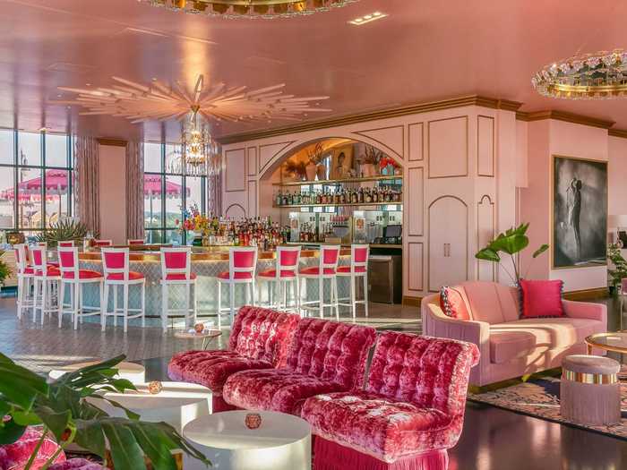 ... or lounge under chandeliers on plush pink coaches while dining on small plates like "Trout Fritters with Almondine Dip" and "Biscuits and Caviar."