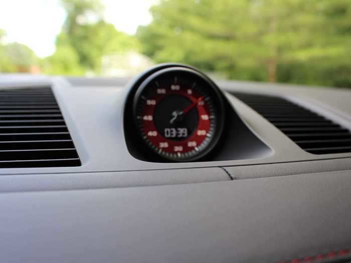 The sport-chronograph lives in the center of the dash — and carries the red from the exterior over into the instrumentation.