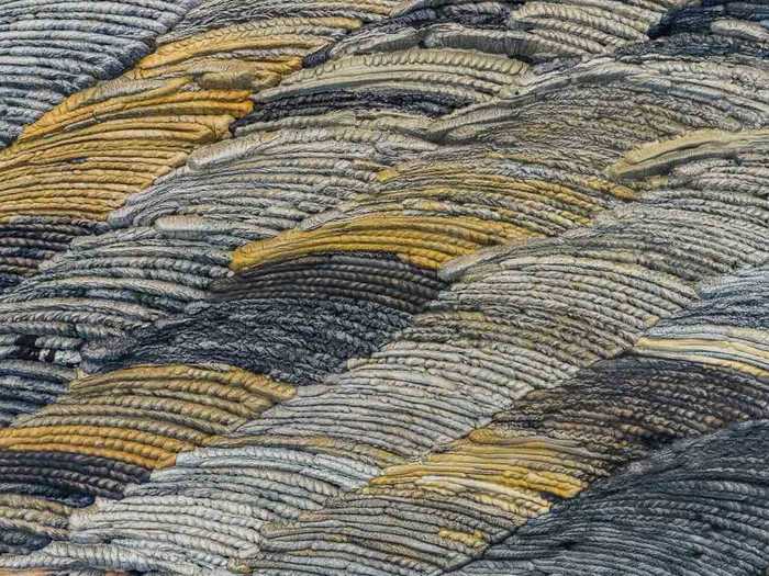 Knowing the subject might ruin the illusion. For example, I initially thought this photo was an extreme close-up of a piece of fabric and was shocked to discover it was of a coal mine in Germany.