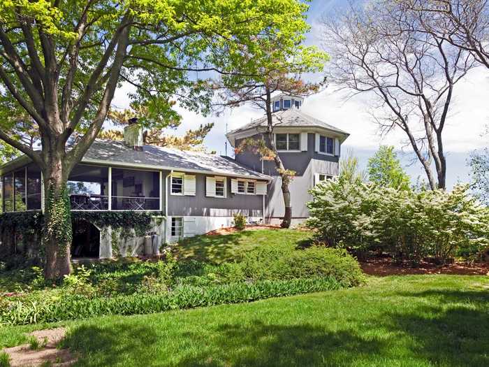 Painted slate gray, it consists of a main level and two-story hexagonal tower reminiscent of a lighthouse.