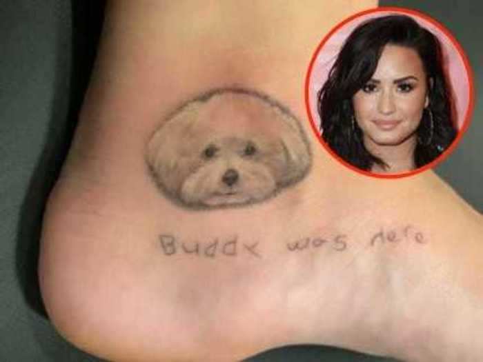 At first, Demi Lovato paid tribute to her dog with just the phrase, "Buddy was here," but she added his portrait in January 2019.