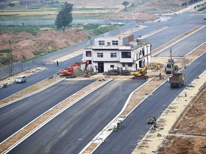 Then there are the houses that become impossible-looking because of their surroundings. In China, so-called "nail houses" emerge when development continues around a house after its owners refuse to leave.