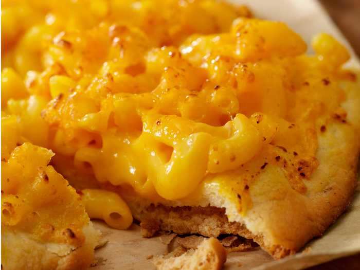 This pizza topped with creamy mac and cheese looks out of this world.