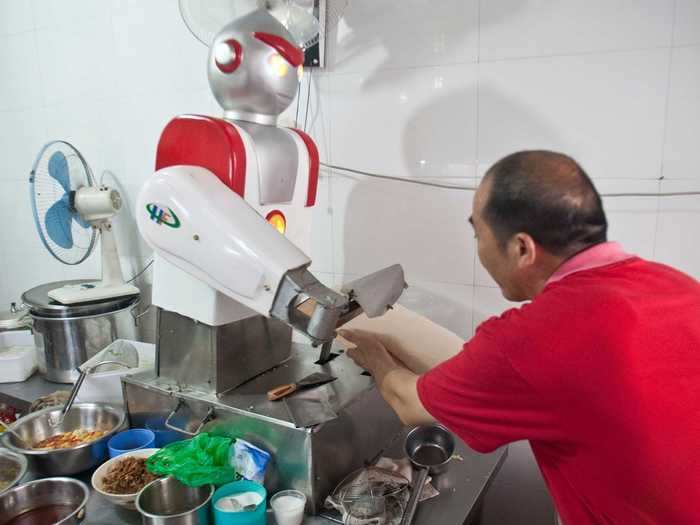 A restaurant in Hangzhou, China has a robot chef that looks like Ultraman, a Japanese anime character. This chef robot slices noodles in the kitchen.