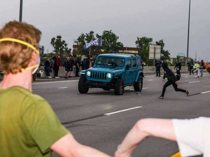 The demonstration took a violent turn when a car drove into the crowd protesters and at least one person was shot in the chaos.