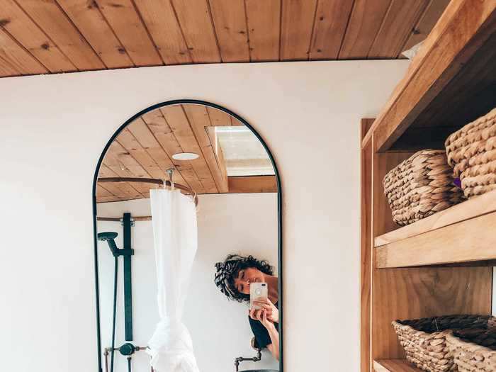 The bathroom is designed with wooden features as well.