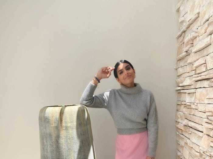 On Monday, Bansal wore a pink slip dress with a sweater over the top to head into Venus Et Fleur