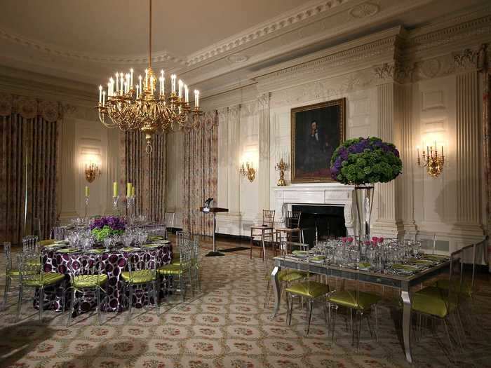 A funky purple tablecloth with green chair cushions brightened up the State Dining Room in 2012 when David Cameron visited the White House.