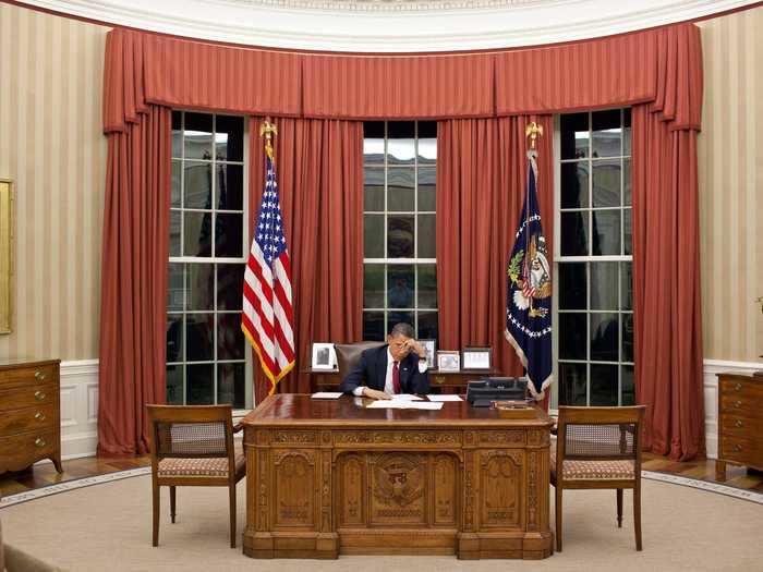 Barack Obama added red curtains, striped wallpaper, and a new rug also made by The Scott Group.