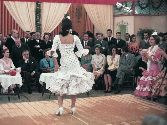 While in Seville, Kennedy was spotted giggling while watching a Flamenco concert with Princess Grace of Monaco and her husband, Prince Rainier.