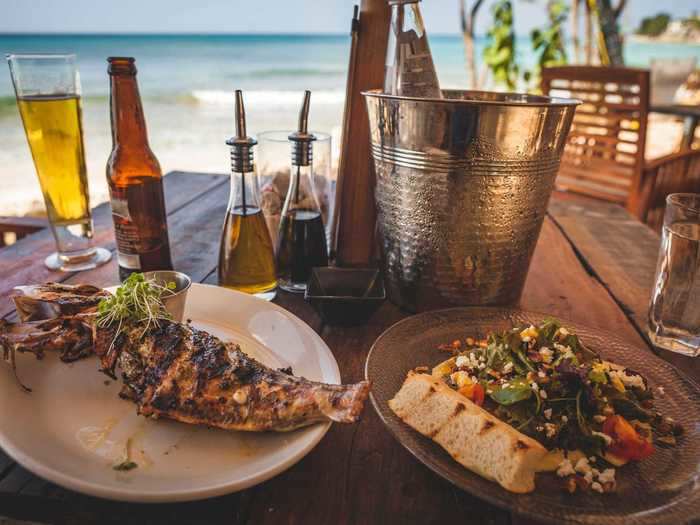 A drink or two and a plateful of fresh food always tastes better by the sea.