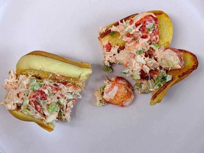 The first thing we noticed was that the roll from Lobster Roll had bigger chunks of meat, more celery, and a more red hue. Its bun was also more toasted than that of Clam Bar.