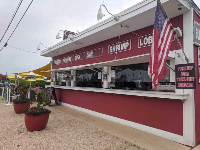 Clam Bar is a lot more low-key and describes itself on its website as "roadside rustic" with a "no-frills ambiance." It has outdoor dining only, at plastic tables in the shade of yellow-and-white umbrellas.