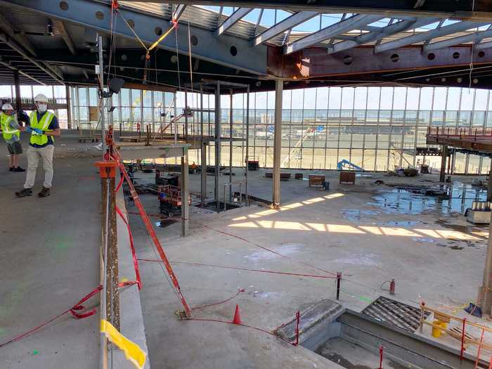 Yet-to-be-installed escalator and elevator banks on each end of the balcony then bring passengers down to the concourse level.