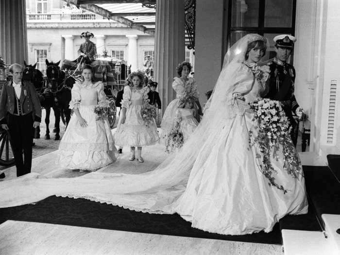 This black and white image of the bride and groom walking with their wedding party behind them stands out as one of the most candid photos from the event.