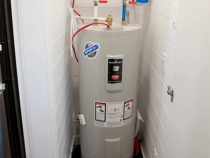 The utility room most prominently holds the hot water tank.