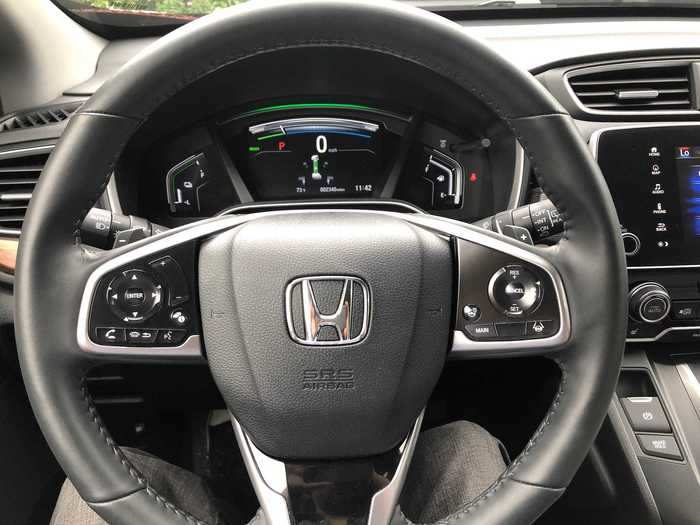 The paddles behind the leather-wrapped, multifunction steering wheel control the intensity of the regenerative braking. Not a feature I have on my RAV4 (which also has regen braking, just not on demand). The instrument cluster is also fully digital.